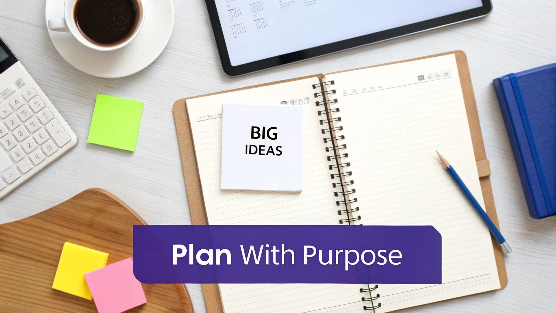 A flat lay of a workspace with an open notebook, 'BIG IDEAS' sticky note, coffee, and planning tools.