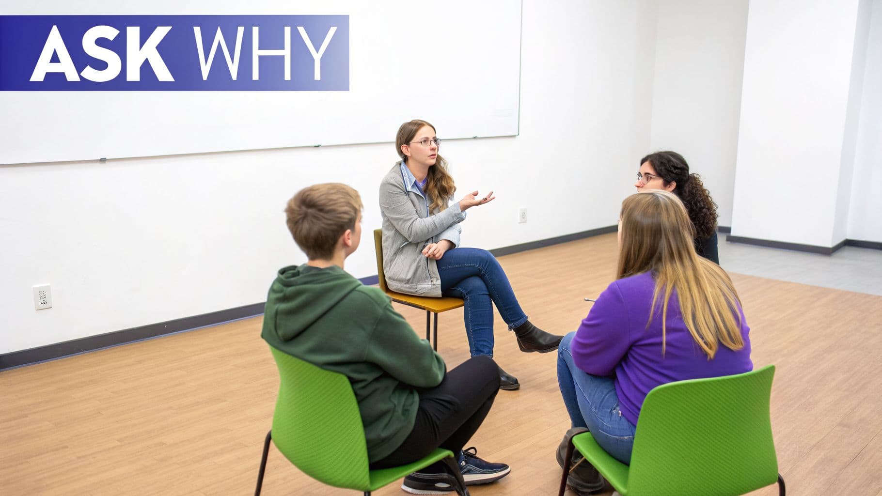 Four people sit in a semi-circle, with one woman speaking and others listening intently.