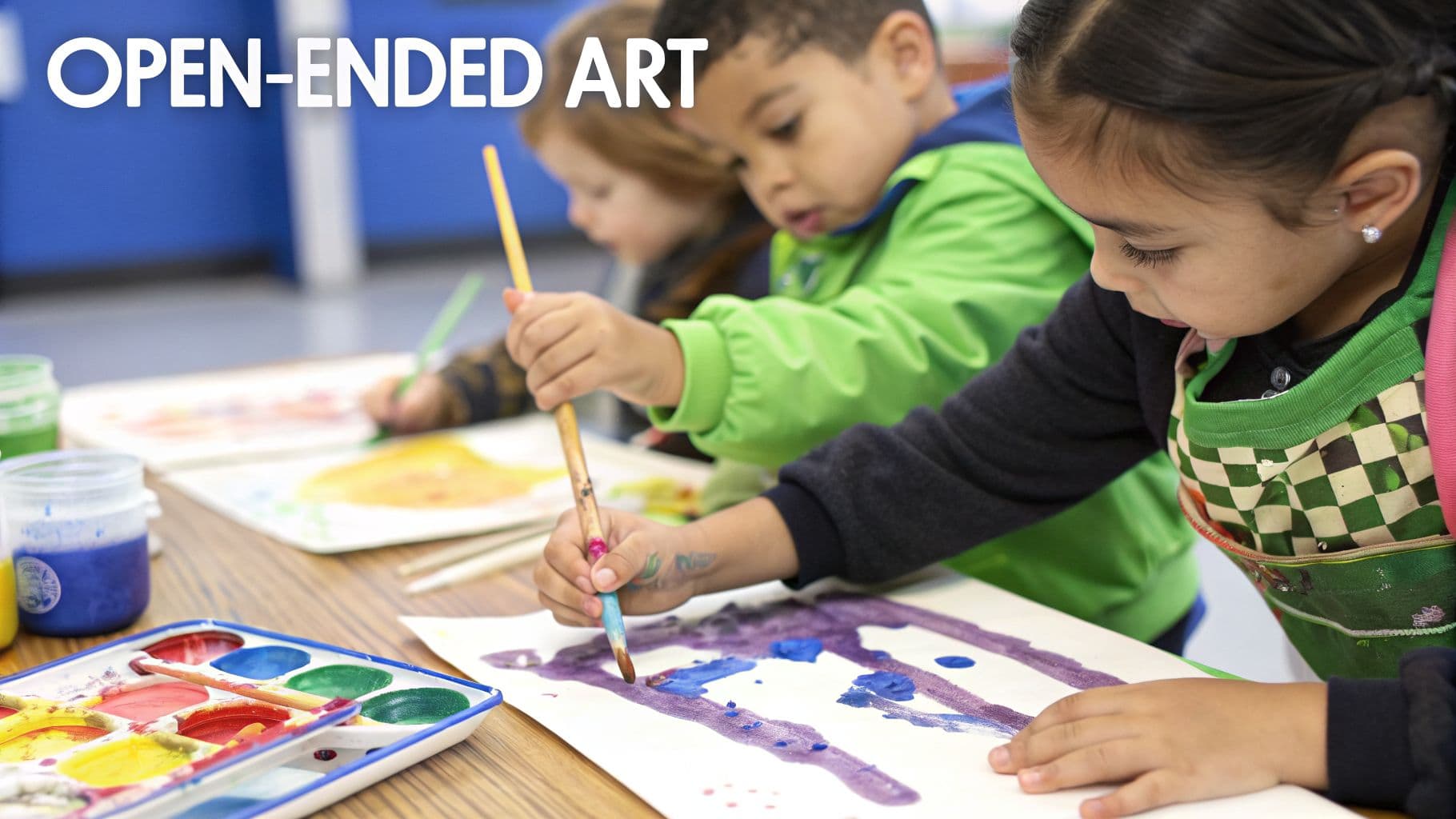 Young children enthusiastically paint with watercolors and brushes during an open-ended art activity.