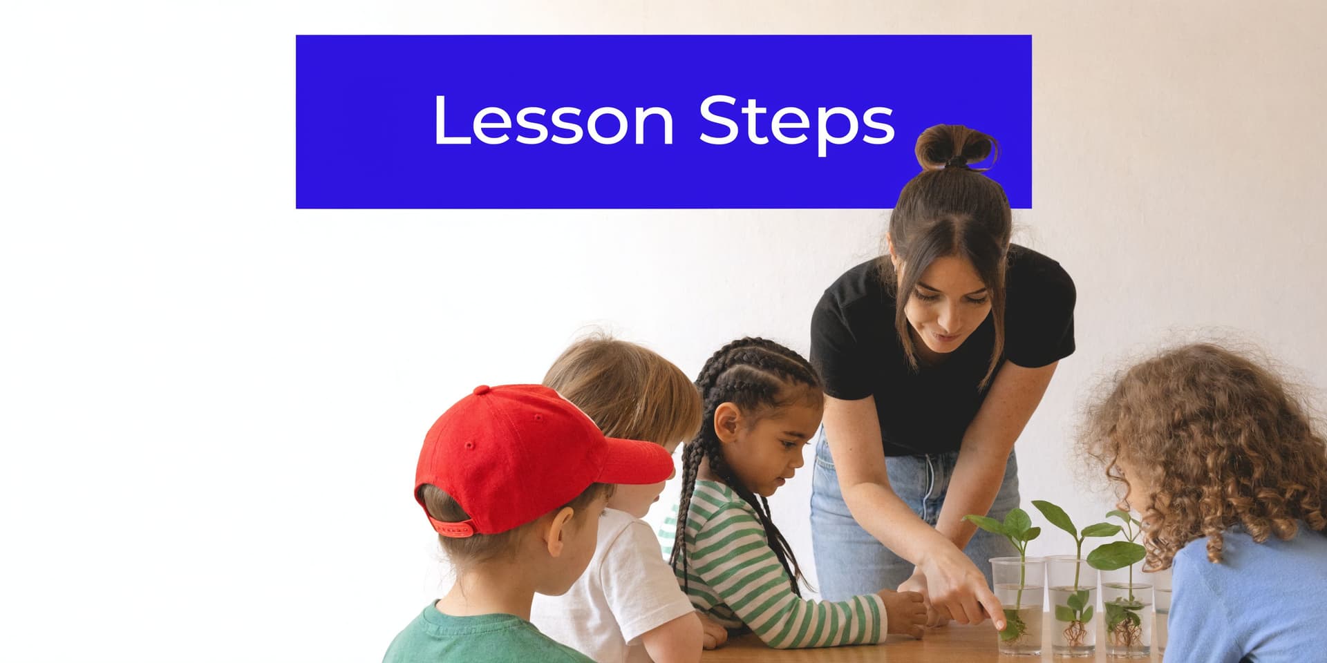 A teacher shows kindergarten children how to observe plant root growth in small clear plastic cups.