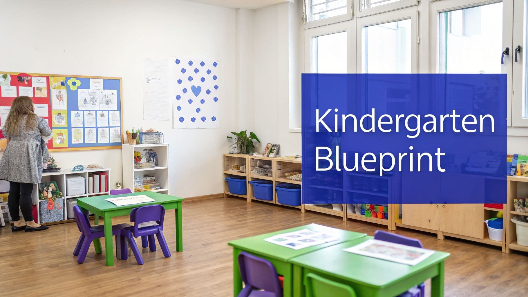 A bright, organized kindergarten classroom with colorful furniture, children's artwork, and learning materials.